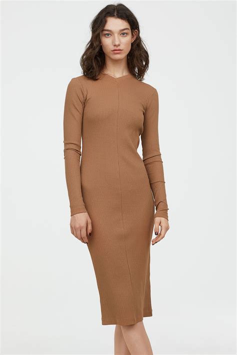 Black. Free standard delivery for Members when spending £30 or more. Free Click and Collect. Free and flexible returns for members. Calf-length dress in a rib knit with a fitted bodice and an asymmetric neckline with one wide shoulder strap. Gently flared skirt with an inset at one side to create an asymmetric hem.